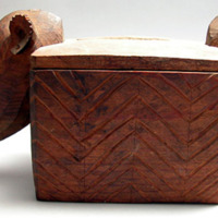 Box, lidded, zigzag incised designs, 2 animal heads with long snouts at ends
