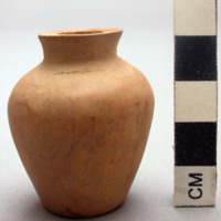 Small carved wooden jar or bottle without a stopper, plugged bottom. H: 4.5 cm.