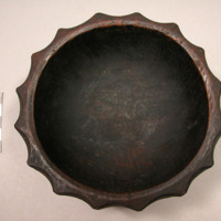 Dark-colored carved wooden bowl with scalloped edges, diameter of base: app. 9.5