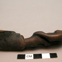 Wooden spoon, handle carved in human effigy: female, hands resting on flexed kne