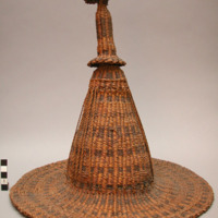 Coiled basketry hat, horizontal stripes, alternating dark and natural