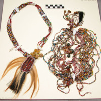 Bead necklace with hair pendants