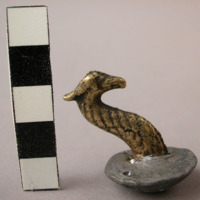 Brass and lead object (button?). brass serpent's head. height: 3.2 cm.