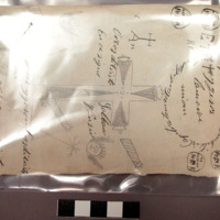 Label, paper, rectangular, ink inscriptions, pencil drawings of cross and faces