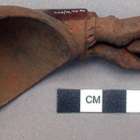 Wooden spoon, handle carved in human effigy: hands resting on flexed knees, no h
