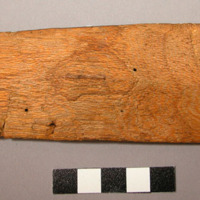 Carving, shield for figurine, wood, bulge at front center, perforated at back