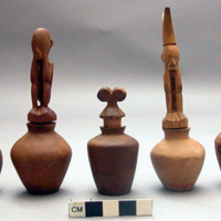 Wooden lime bottles with effigy stoppers